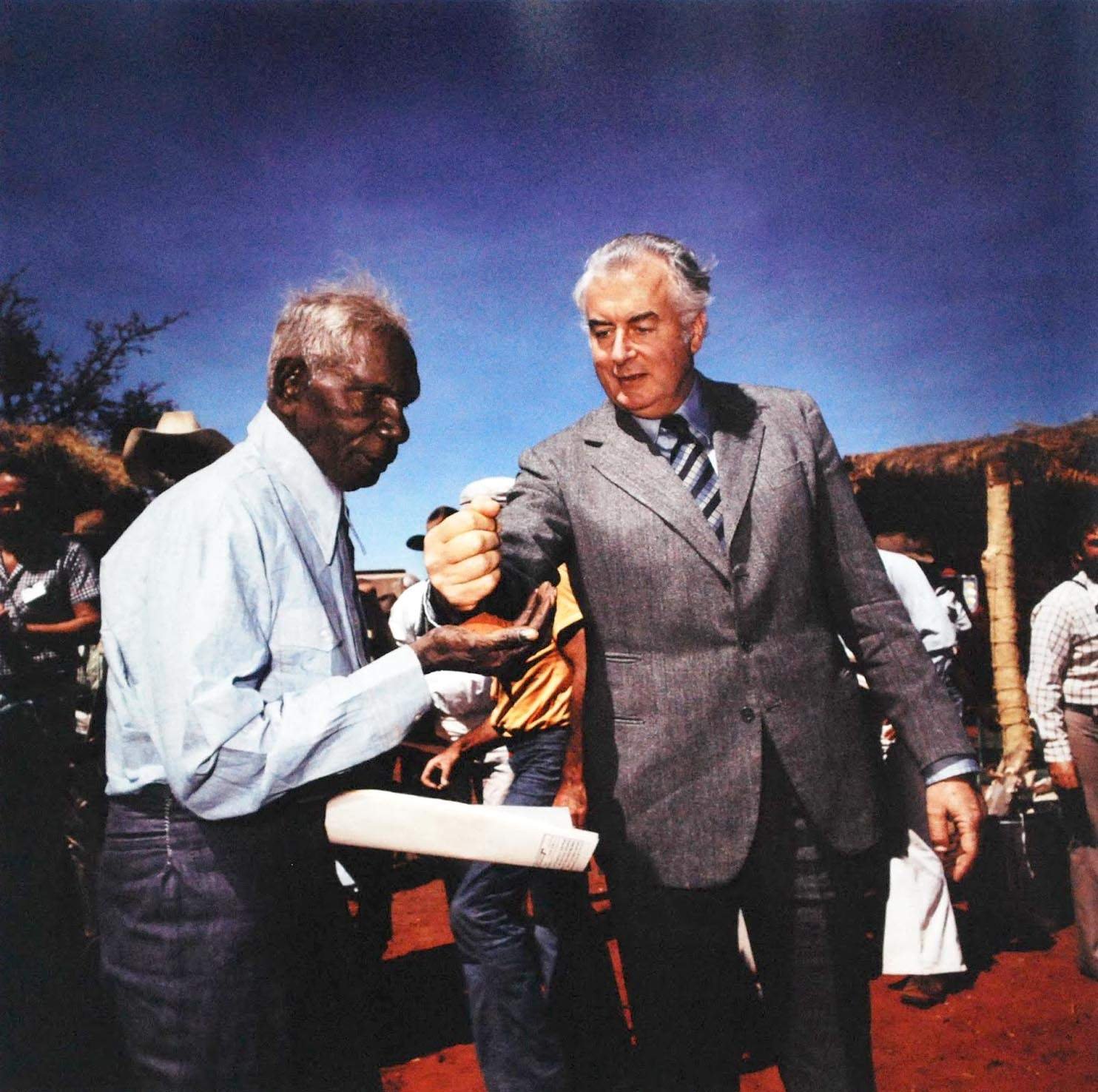 Vincent Lingiari accepts a handful of the Centre's red sand from Prime Minister Gough Whitlam